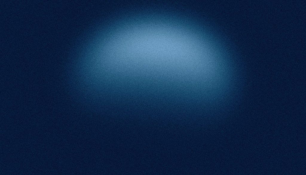 A dark blue background with a bright spotlight.